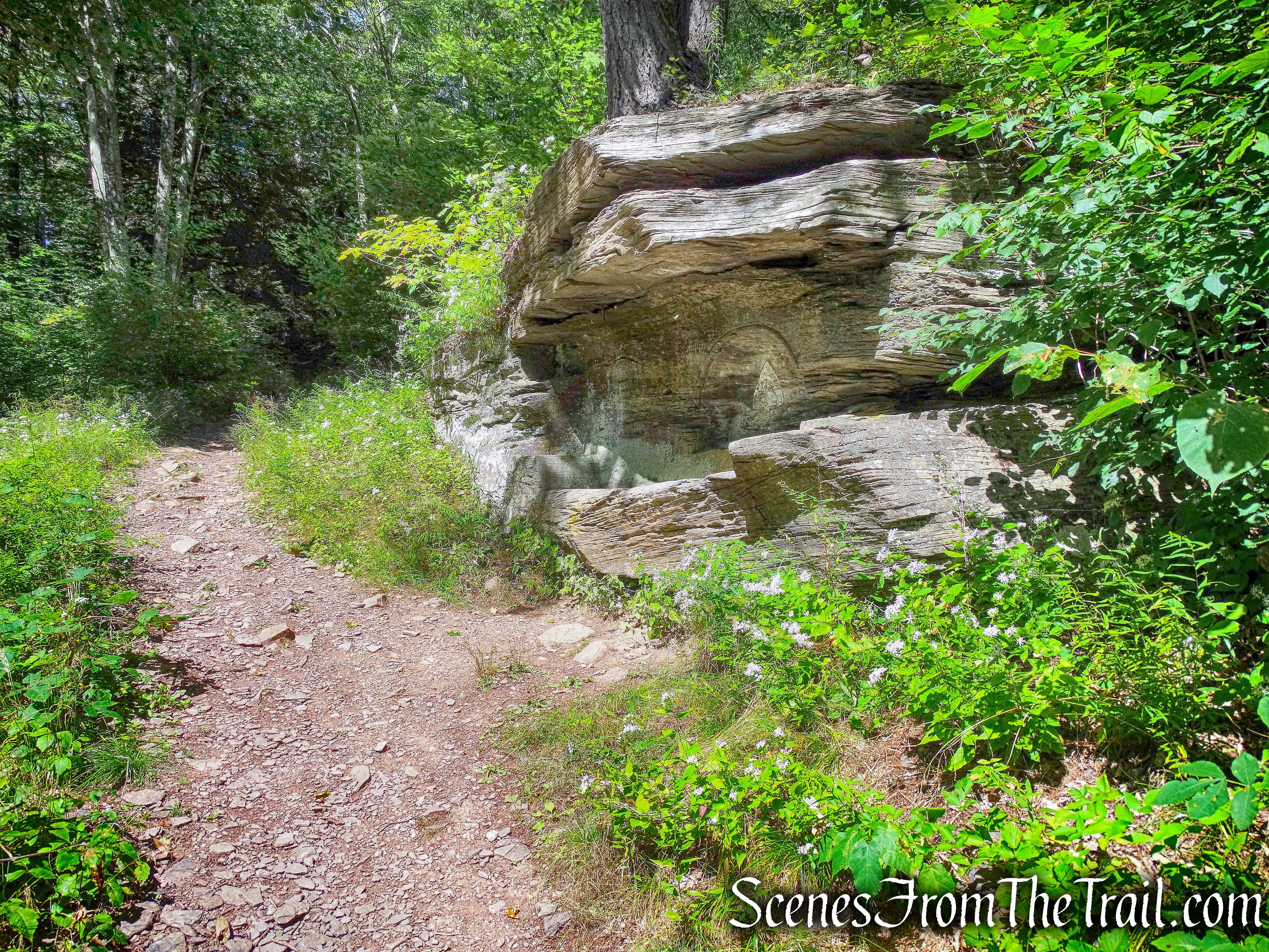 large boulder with bench