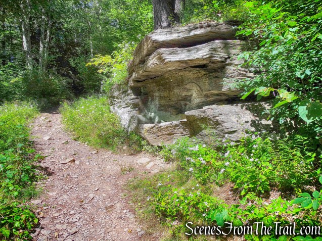 large boulder with bench