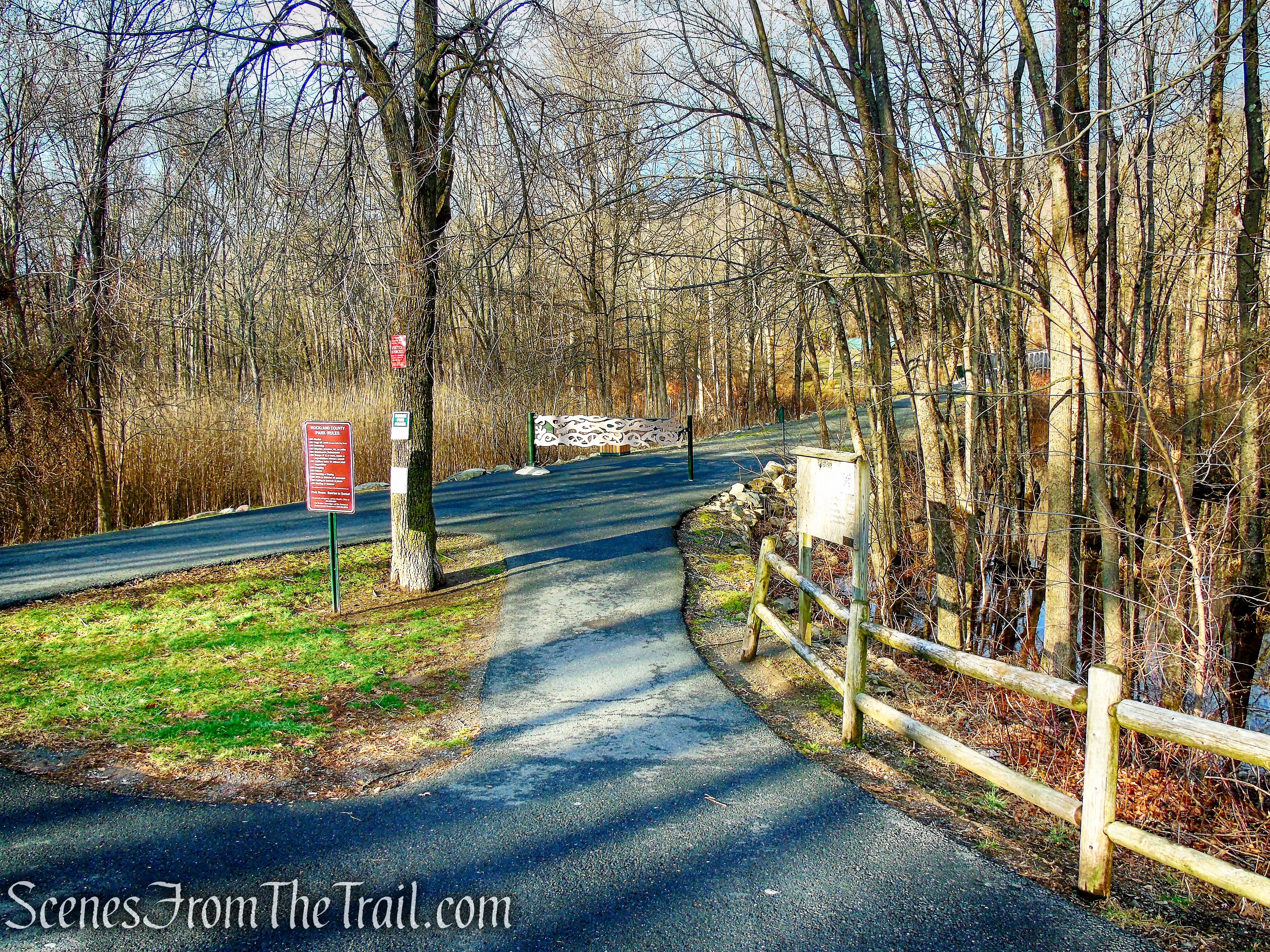 Proceed on the paved walk past the metal gate
