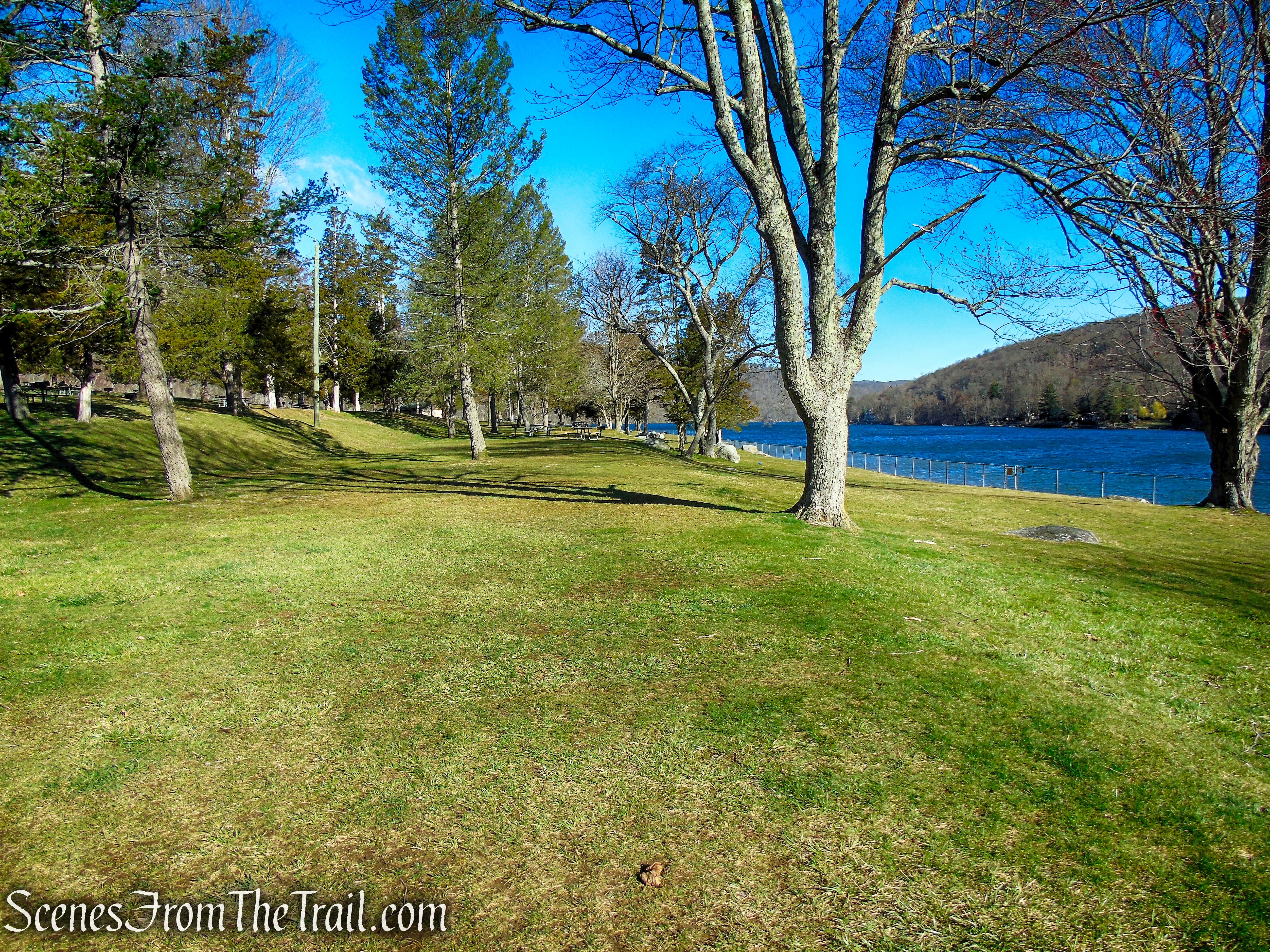 Head north towards the beach area.
