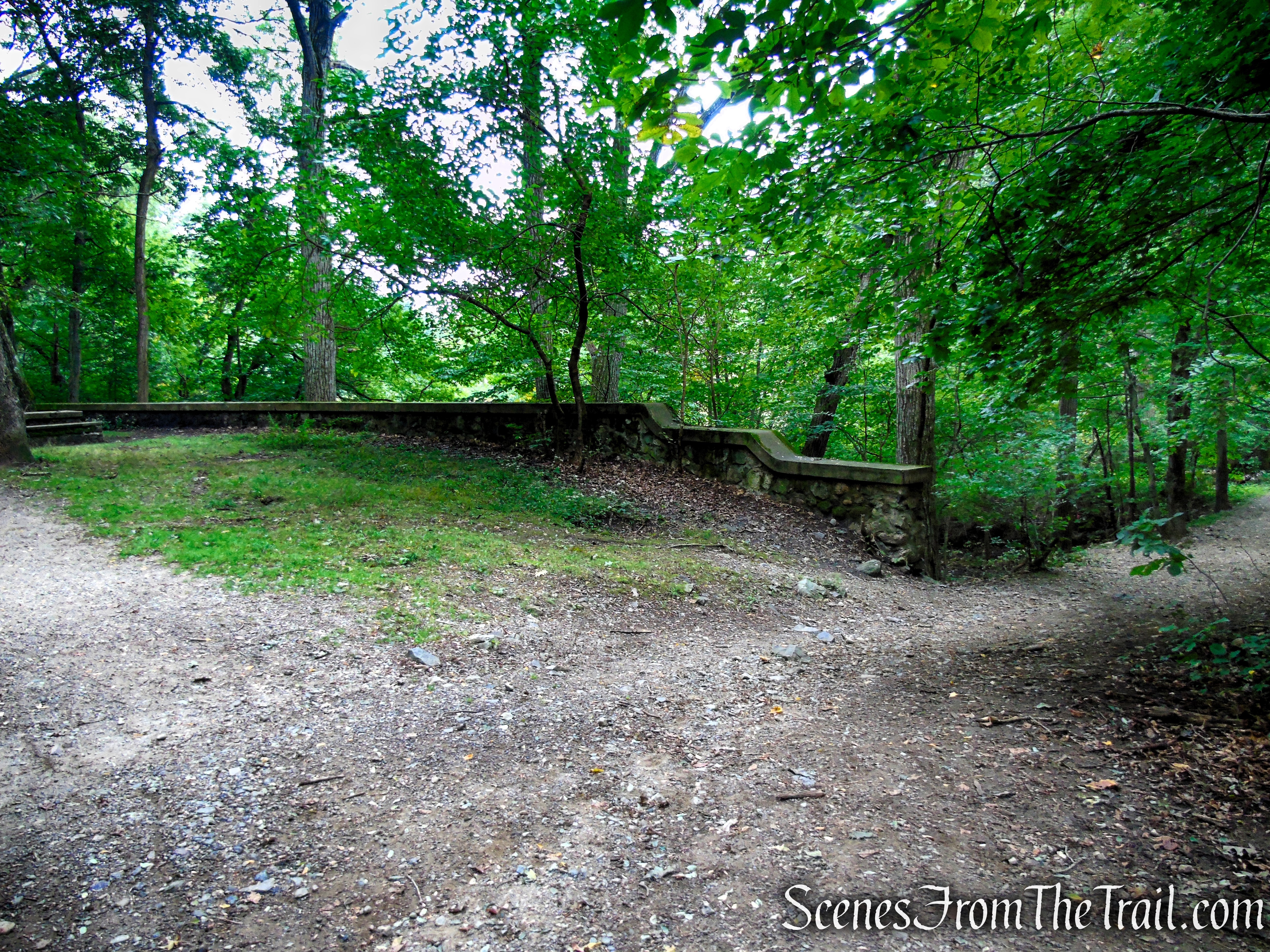 Turn right by the stone wall