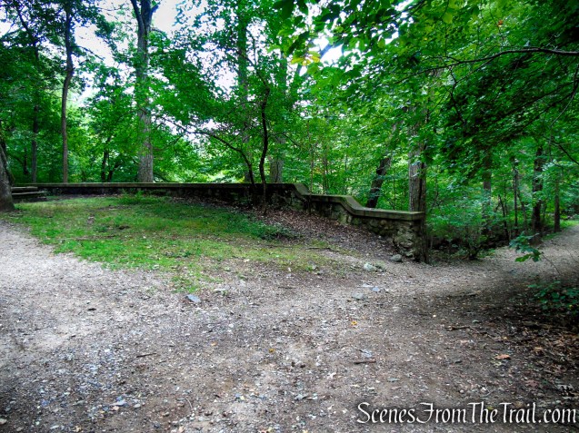 Turn right by the stone wall